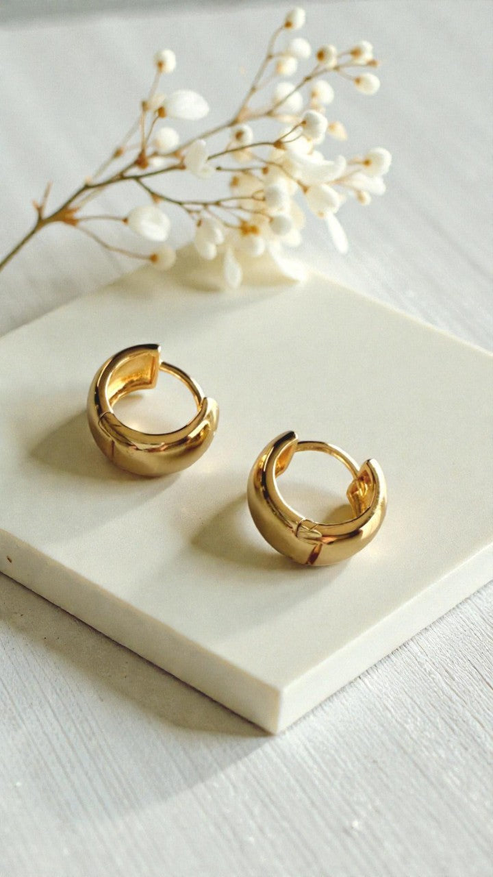 Aretes tipo argolla dorada de diseño minimalista